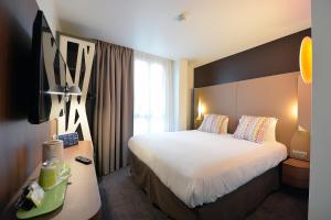 a hotel room with a bed and a desk at CAMPANILE PARIS - Clichy Centre in Clichy