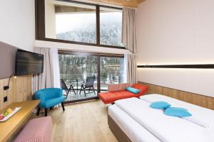 ein Hotelzimmer mit einem Bett und einem großen Fenster in der Unterkunft Hotel Palü in Pontresina