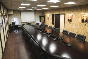 a conference room with a long table and chairs at Okhotnik Hotel in Moscow
