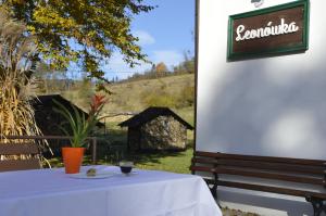 a table with a plate of food and a sign at Leonówka Bieszczady in Cisna