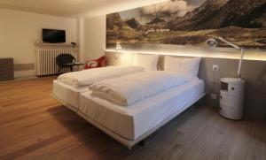 Rúm í herbergi á Hotel & Restaurant Forni