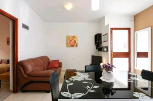 a living room with a couch and a table at Apartments Rena & Filip, by the beach in Preko