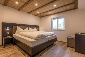 a bedroom with a large bed and a window at Haus Bergsonne in Saas-Almagell