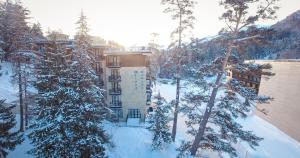 an aerial view of a building in the snow at BM Plaza in Bakuriani +46 photos