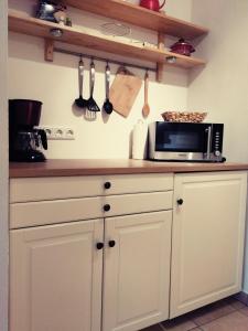 a kitchen with a microwave on a counter with utensils at Haus Schwarzeck in Ramsau