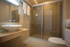 a bathroom with a sink and a shower at BM Plaza in Bakuriani