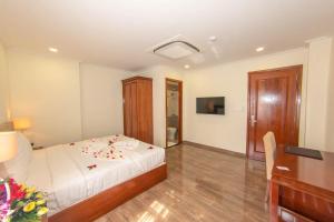 Postel nebo postele na pokoji v ubytování Trường Hải Hotel