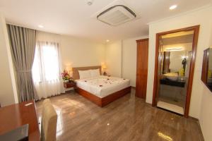 Postel nebo postele na pokoji v ubytování Trường Hải Hotel
