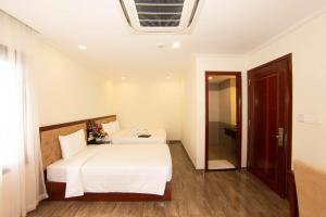 Postel nebo postele na pokoji v ubytování Trường Hải Hotel