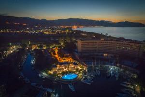 a view of a hotel and a city at night at Residence Delfino, Portorosa in Furnari