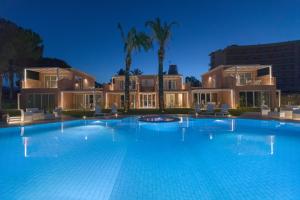 a large swimming pool in front of a house at Residence Delfino, Portorosa in Furnari