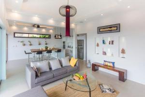 a living room with a couch and a table at Stunning sea view villa Lamai Koh Samui in Lamai