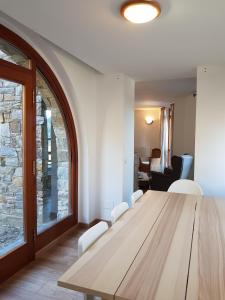 a dining room with a wooden table and chairs at Soldeu Paradis Pleta in Soldeu