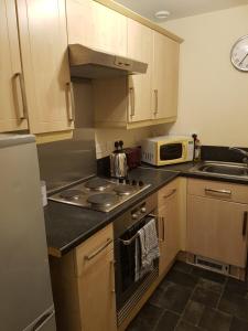 a small kitchen with a stove and a microwave at Livingston Business and Contractor Apartment in Livingston