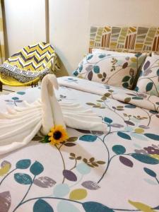 a bed with a flower on top of it at VL Garden Suites in Tagbilaran City