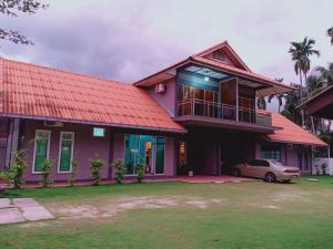 a house with a car parked in front of it at Villa Sri Tebengau in Kuah