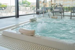 a hot tub with water in it in a building at Aparthotel Dunes Platja in Can Picafort
