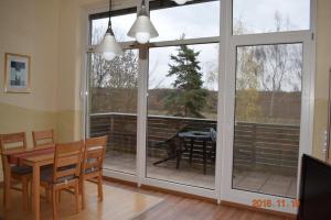 a dining room with a large sliding glass door at Ferienwohnung Weinlaube in Bergrheinfeld
