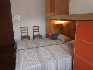 A bed or beds in a room at Checchi House