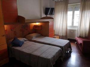 A bed or beds in a room at Checchi House