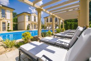 a row of chaise lounges on the patio of a house at Luxury-Villas in Sopron