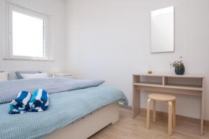 a bedroom with a bed and a table and a stool at Sunrise Apartments Bol in Bol