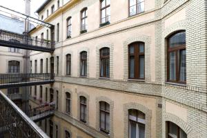 a large brick building with windows and a balcony at Karikum Large in Budapest