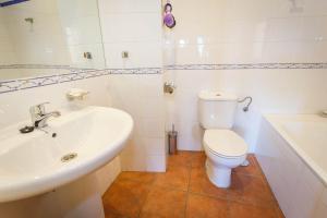 a white bathroom with a sink and a toilet at El Bulin de Paredes in Paredes de Buitrago +23 photos