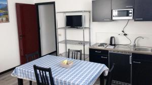 a small kitchen with a table with a box on it at Studio CENTRAL 2 in Aosta