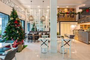a christmas tree in the dining room of a restaurant at White Ivory Bed And Breakfast in Bangkok