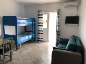 a living room with a bunk bed and a couch at Doci Seven Hotel in Velipojë