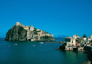 an island in the water with buildings and boats at Boutique House Fiò in Ischia