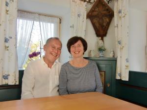 a man and a woman sitting at a table at Pension Kainzer Sölde in Velden