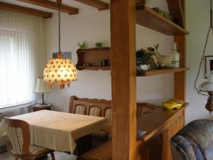 a dining room with a table and a room with a dining room at Ferienhof Hoppe in Wildewiese