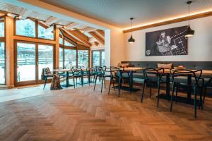 a dining room with tables and chairs and large windows at Haus Ennsegg by Schladming-Appartements in Haus im Ennstal +21 photos