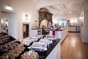 
a kitchen filled with lots of different types of food at Schlosshotel Münchhausen in Aerzen
