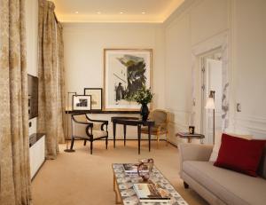 a living room with a couch and a table at Hotel Eden - Dorchester Collection in Rome