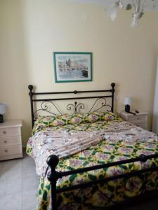 a bedroom with a bed with a quilt on it at Affittacamere Graziella in Vernazza