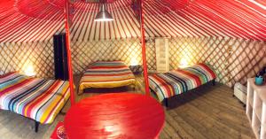 a room with two beds in a yurt at Yourtes Mongoles Gavarnie in Gèdre