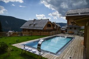 einen Pool auf einer Terrasse mit einem Haus in der Unterkunft Almdorf Seinerzeit in Patergassen