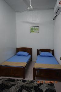 1 Schlafzimmer mit 2 Betten in einem Zimmer in der Unterkunft RILEK-RILEK HOMESTAY in Jertih