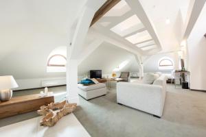 a living room with white furniture and a white ceiling at Hotel Jakubus in Wilków