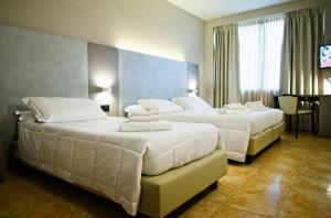 Ένα ή περισσότερα κρεβάτια σε δωμάτιο στο Albergo Papillon
