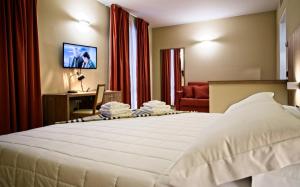 Ένα ή περισσότερα κρεβάτια σε δωμάτιο στο Albergo Papillon