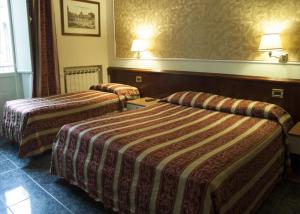 Postel nebo postele na pokoji v ubytování Hotel Agorà