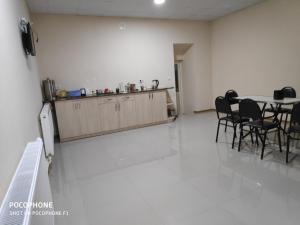a kitchen and dining room with a table and chairs at Ideal in Akhalk'alak'i