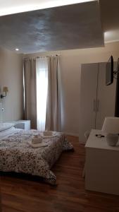 a white bedroom with a bed and a window at Albergo la Svolta in Brescia