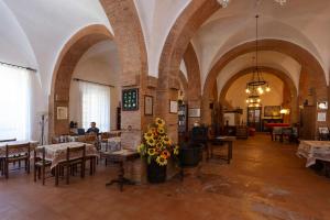 a large room with tables and chairs in a building at Residence Villa Elena in Guardistallo