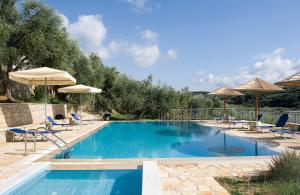 a large swimming pool with chairs and umbrellas at Panorama Gialovas in Gialova