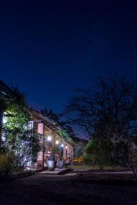 a building lit up at night with lights at Sougri Doogo in Loumbila